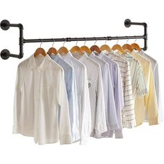 several shirts are hanging on a rail and some hangers have clips attached to them