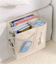 a white storage bag filled with books on top of a bed