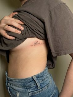 a woman with a small tattoo on her stomach