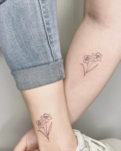 two people with matching tattoos on their arms