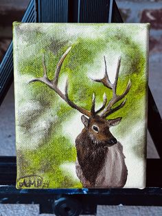 a painting of a deer with antlers on it