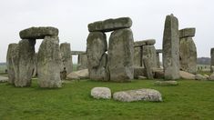 the stonehenge monument in england is surrounded by large rocks and grass on a cloudy day