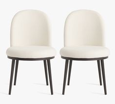 two white chairs sitting side by side on top of each other, one with black legs