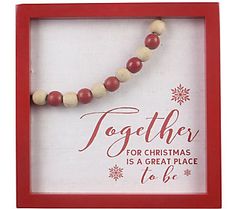 a red and white beaded necklace in a frame with the words together for christmas is a great place to be