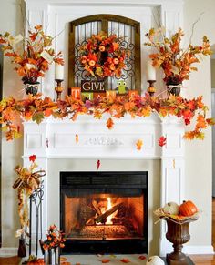 the fireplace is decorated with fall leaves and candles