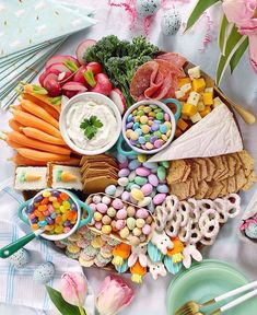 a platter filled with lots of different types of food on top of a table