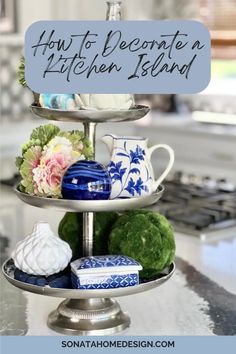 A tiered tray holding faux florals, ceramic pitcher, and home decor. Everyday Table Centerpiece, Everyday Table Centerpieces, Island Decor Ideas, Kitchen Island Decor Ideas, Table Centerpiece Ideas, Bold Living Room, Kitchen Island Decor, Island Decor, Elegant Centerpieces