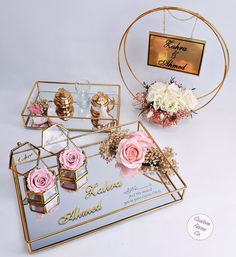 a display case with flowers and jewelry on it