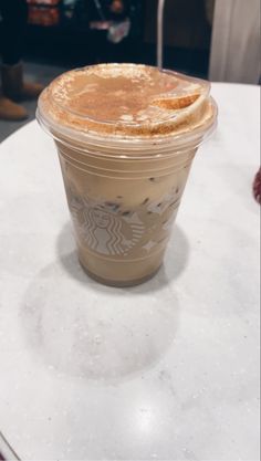 a starbucks drink sitting on top of a table