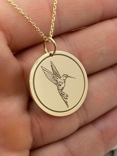 "14k Solid Gold Hummingbird Necklace, Personalized Hummingbird Pendant, Hummingbird Jewelry 14k Solid Gold Choose What Size You Want the Pendant Using The First Option Box Choose Chain Length Or Without Chain Using The Second Option Box Photos Are For The 25.4 mm / 1 Inch Diameter Pendant Pendant thickness : 0.7mm  Contact us if you want it thicker Inner diameter of jump ring : 5mm Contact us if you need it bigger  Chain width : 1.30mm     ♥  Material of pendant and chain: Solid Gold k14  ♥  Packaging: All of our jewelry are beautifully boxed and ready for gifting For more personalized designs take a look here: ♥ www.etsy.com/listing/736955132 ♥ www.etsy.com/listing/819494857 ♥ www.etsy.com/listing/823397880 ♥ www.etsy.com/listing/769847320 ♥ www.etsy.com/listing/872949017 ♥ You can send u Gold Hummingbird, Hummingbird Jewelry, Hummingbird Necklace, Hummingbird Pendant, Preppy Jewelry, Second Option, Necklace Personalized, Gold Style, Chain Length