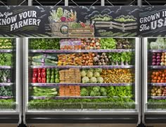 an assortment of fruits and vegetables on display in a grocery store