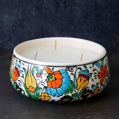 * Large size handpainted colorful floral ceramic candle bowl. * Measures 6.25" diameter and 3" height. * Hand-poured lavender scented wax. * Iznik pottery ceramic bowl. * Made in Iraq.---------------------------------Our Iznik collection includes Iznik pottery vessels filled with lavender wax by Iraqi women. The collection provides support to Iraqi women and also preserves the traditional Iznik pottery. The collection is painted vibrant colors and patterns that are inspired from the time during Pottery Vessels, Prosperity Candle, Marble Rolling Pin, Floating Candles Bowl, Candle Bowl, Small Ceramic Bowl, Hand Painted Bowls, Ceramic Tumbler, Bowl Candle