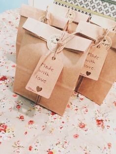 two brown bags with tags on them sitting on a table