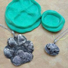 three pieces of jewelry sitting on top of a table next to an empty cookie sheet