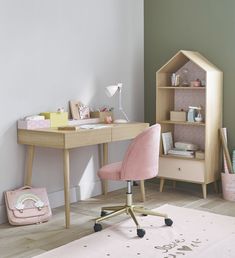 a child's desk with a pink chair next to it and a book shelf