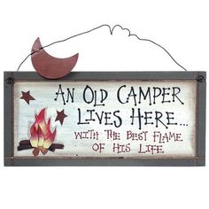 an old camper lives here sign with the best flame of his life on it