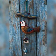 a wooden door with a bird hanging from it's side