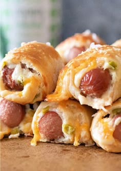 several hot dogs wrapped in crescent pastry on a table