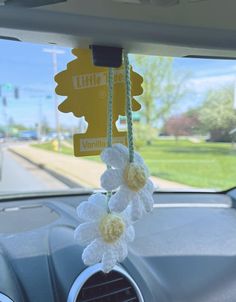 the interior of a car with flowers hanging from it's dash board