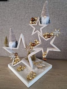 an ornament is set up on a table with christmas decorations and ornaments in it