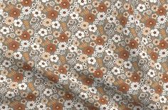 an orange and white flowered fabric with brown flowers on the bottom half of it