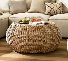 a wicker coffee table with drinks on it