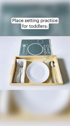 a place setting practice for toddlers is displayed in a tray with utensils