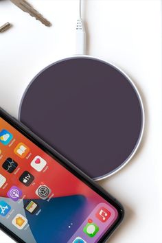 an iphone is next to a wireless charger