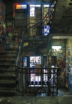 a stairwell with graffiti on the walls and stairs