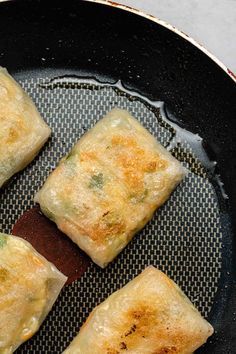 four pieces of food sitting in a frying pan