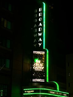 the neon sign for broadway is lit up in the dark at night with green lights