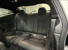 the interior of a car with black leather seats