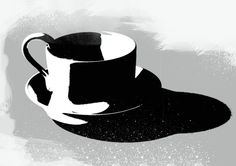 a black and white coffee cup sitting on top of a saucer