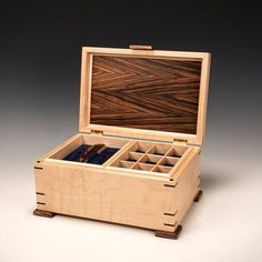 an open wooden box containing several compartments