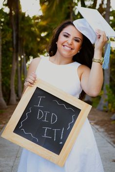 a woman holding a chalkboard with the words i did it written on it