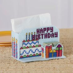 a tissue box with a birthday cake on it