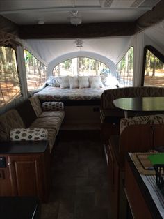 the inside of a camper with couches and tables