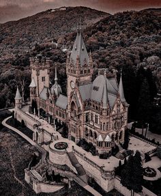 an aerial view of a castle in the mountains