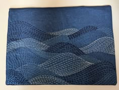 a blue piece of cloth with wavy lines on it