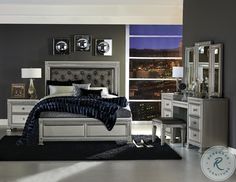 a bedroom with gray walls and white furniture