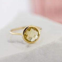 Lemon Quartz ring in 14K solid gold. A modern and timeless ring with a natural lemon quartz yellow stone. A perfect gold ring for women, dainty and subtle that adds glam to every outfit. The best gift for Christmas. 100% handcrafted with love!D E T A I L S● Metal: 14K solid gold, 14K white gold, 14K rose gold● Gemstone: Lemon Quartz, briolette cut, natural gemstone● Stone Diameter: 8mm (0.3in), 10mm (0.4in) and 12mm (0.5in)R I N G ∙ S I Z I N GFor General Reference:● we use standard US Ring Sizi Lemon Quartz Ring, Gold Ring For Women, Birthstone Stacking Rings, Gold Amethyst Ring, Yellow Gems, Timeless Ring, Natural Gemstone Ring, Best Gifts For Her, Gem Ring