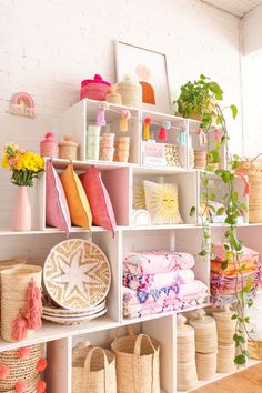 a room filled with lots of different types of baskets and vases on top of shelves