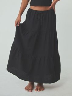 Easy and breezy. This elegant tiered cotton skirt is designed with a versatile waistband that can be worn both high rise or mid-rise, with an adjustable drawstring waist and a three tier design. Details: Drawstring elastic waistband, lined, tiered design Fit: True to Size Fabric: 100% Cotton (Crinkled Texture) Black Tiered Skirt, Elevated Basics, Cotton Skirt, Tier Skirt, Catsuit, Long Sleeve Bodysuit, Cropped Tank Top, Long Maxi Dress, Long Sleeve Maxi Dress