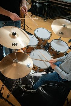 a man sitting in front of some drums