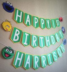 the sesame street birthday banner is hanging on the wall