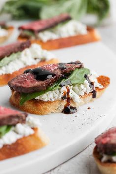 small appetizers with meat, cheese and spinach on bread