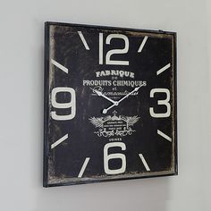 a black and white clock hanging on the wall