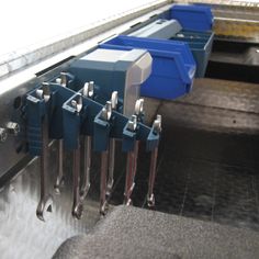 there are many blue and silver boxes on the conveyor belt at this time of day