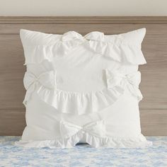 a white pillow sitting on top of a bed