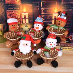 five christmas themed teddy bears sitting in baskets with candles behind them on a table next to books